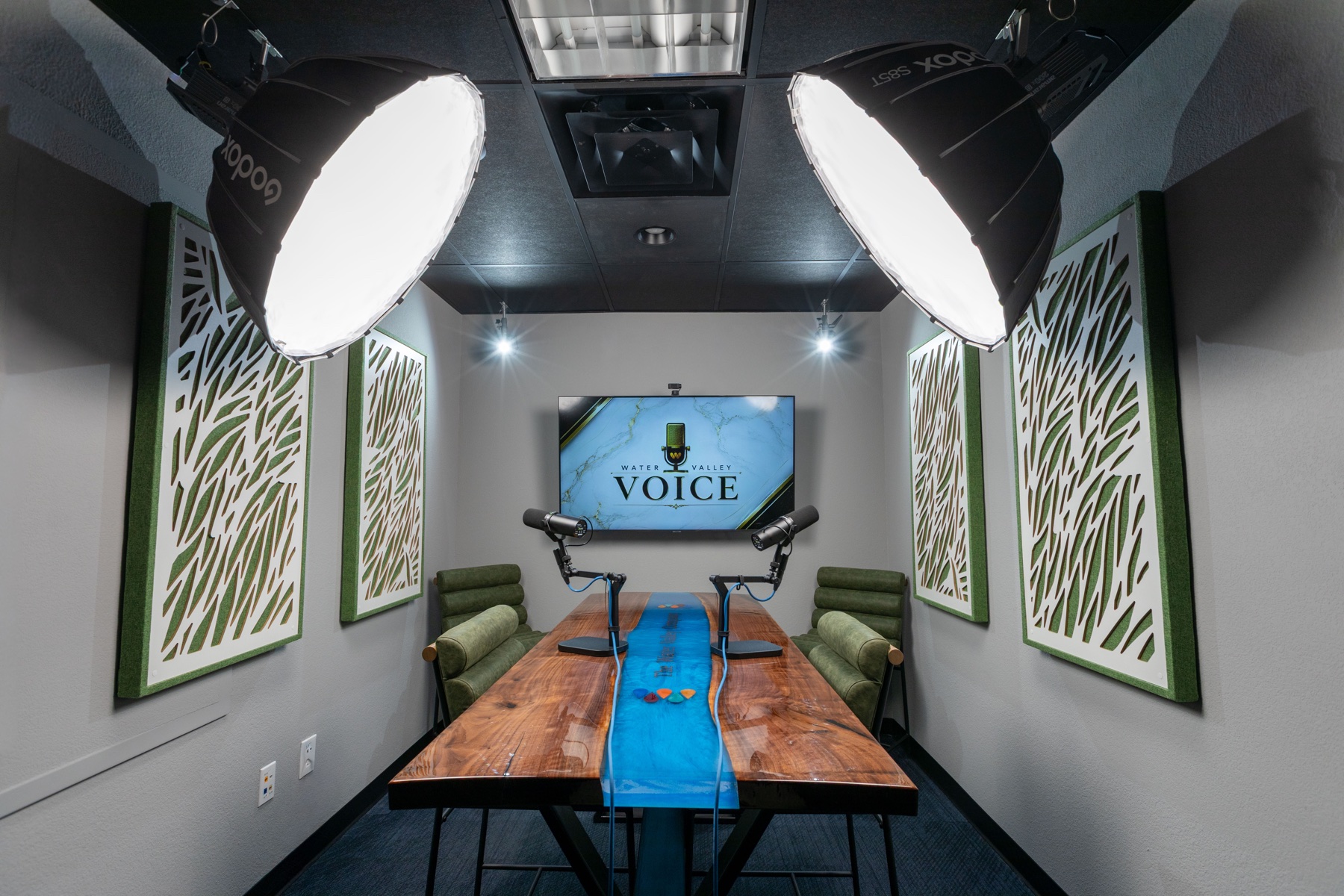 The Water Valley Voice recording studio with microphones and a custom live-edge table